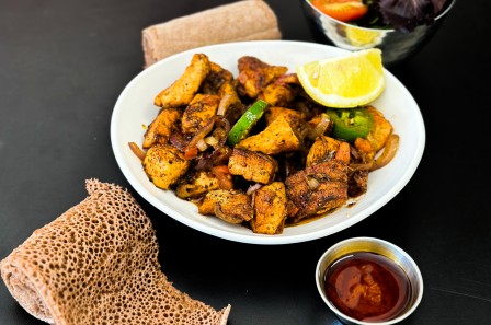 Ethiopian tibs bowl with injera and dipping sauce