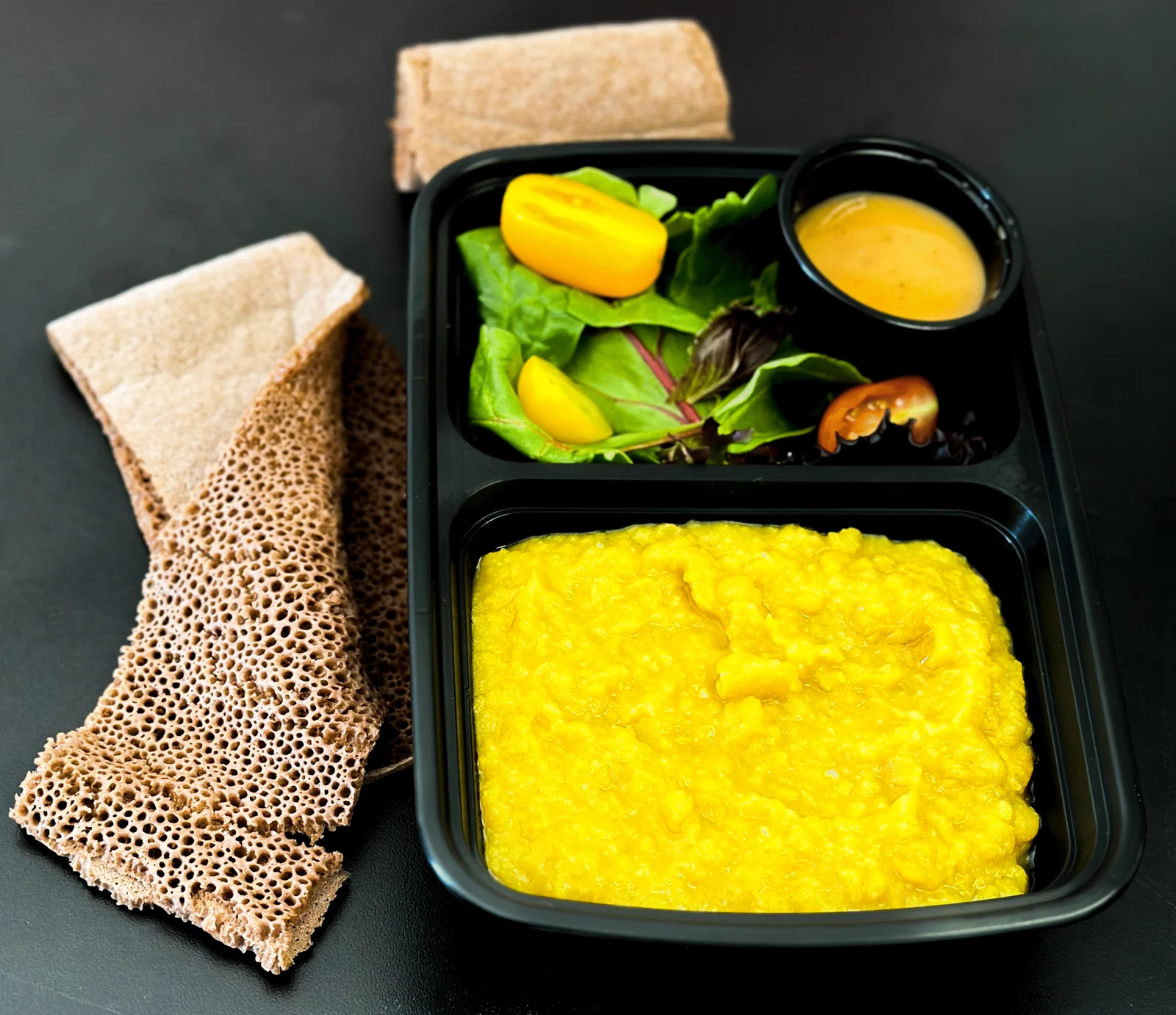 Ater Kik yellow split pea stew with injera and salad