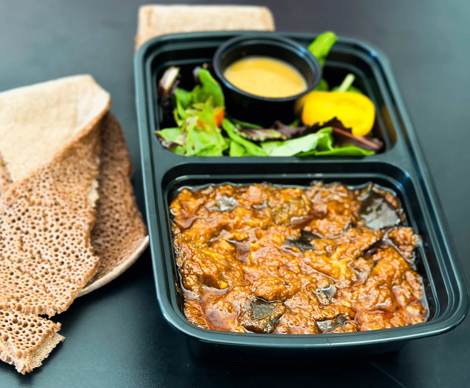 Eggplant Wot with injera and salad