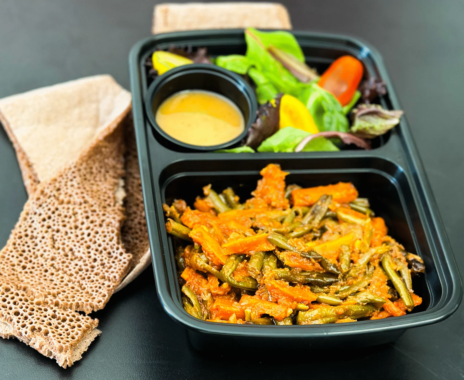 Fasolia green beans and carrots with injera and salad